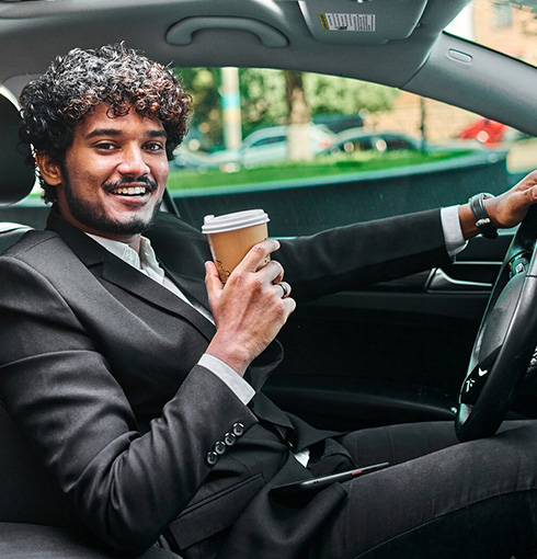 A right close up of a yellow Mercedes AMG sports car headlight on a city street