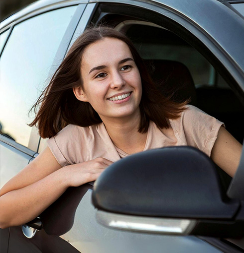 A right close up of a yellow Mercedes AMG sports car headlight on a city street