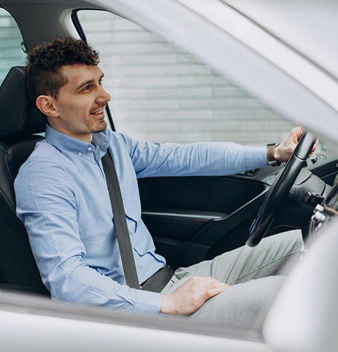 A right close up of a yellow Mercedes AMG sports car headlight on a city street