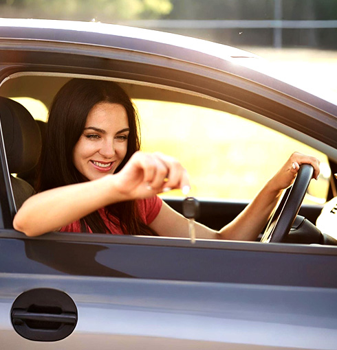 A right close up of a yellow Mercedes AMG sports car headlight on a city street