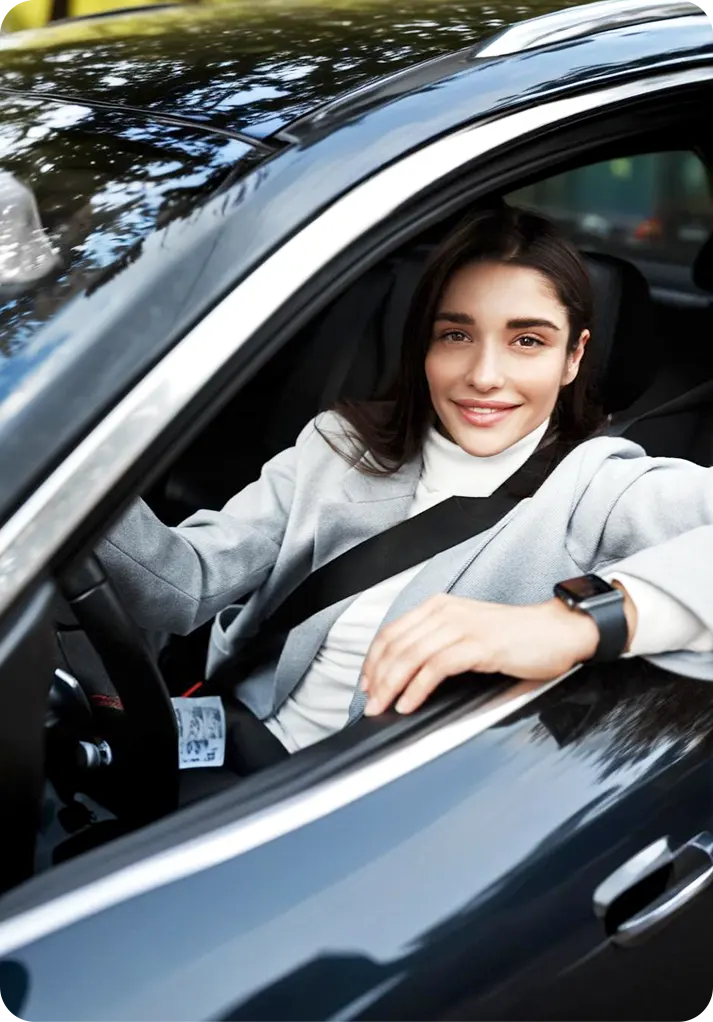 Smiling woman in a car using Selfdrive monthly car hire service in Dubai