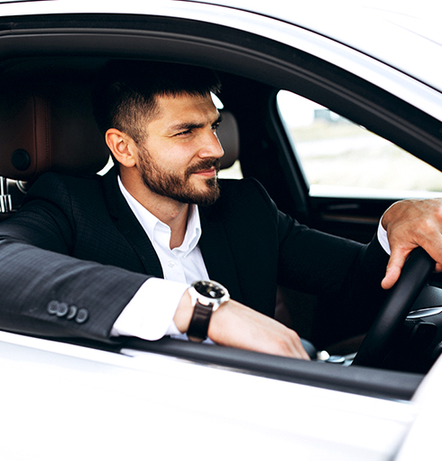 A right close up of a yellow Mercedes AMG sports car headlight on a city street