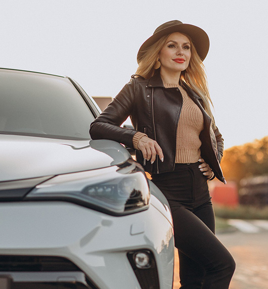 A right close up of a yellow Mercedes AMG sports car headlight on a city street