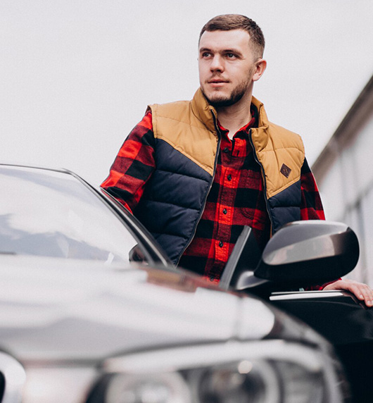 A right close up of a yellow Mercedes AMG sports car headlight on a city street