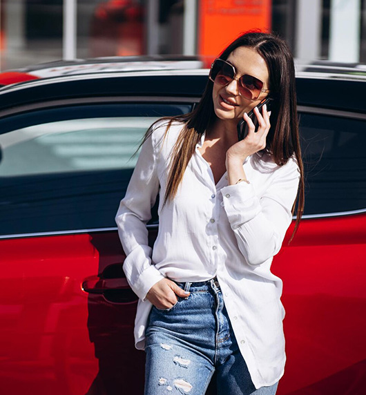 A right close up of a yellow Mercedes AMG sports car headlight on a city street