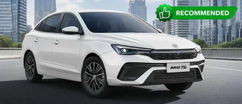 Silver MG 5 sedan parked near a beachside structure with ocean view, available for rent with Selfdrive. 